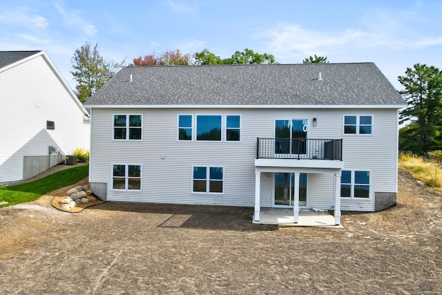 back of property with a patio, a balcony, and central AC unit