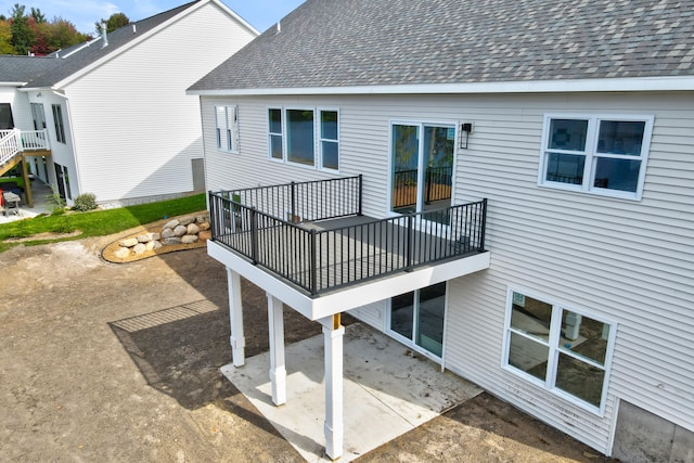 back of house with a patio area and a balcony