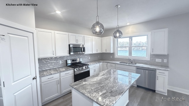 kitchen featuring stainless steel appliances, a center island, and white cabinets