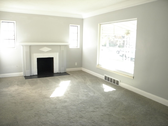 unfurnished living room featuring ornamental molding, carpet flooring, and a brick fireplace