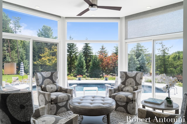 sunroom / solarium featuring ceiling fan