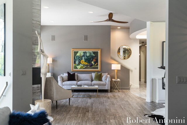 living room featuring ceiling fan and hardwood / wood-style flooring