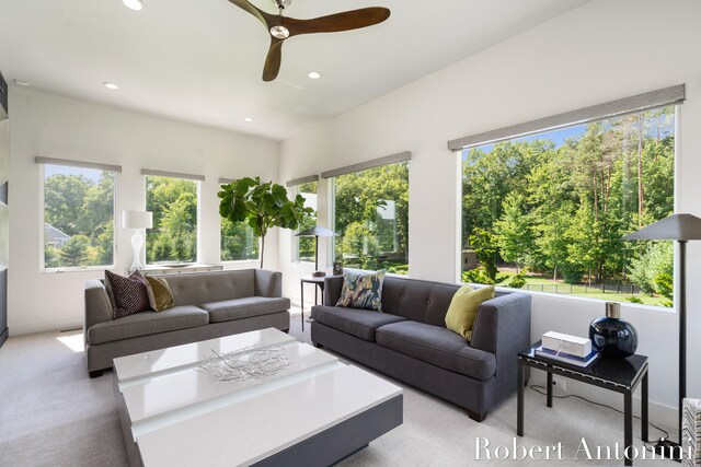 living room featuring light colored carpet and ceiling fan