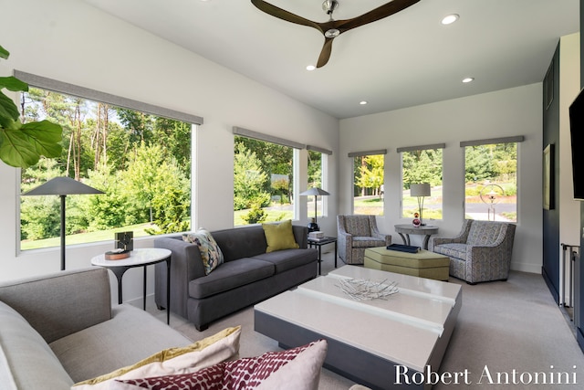 carpeted living room featuring ceiling fan