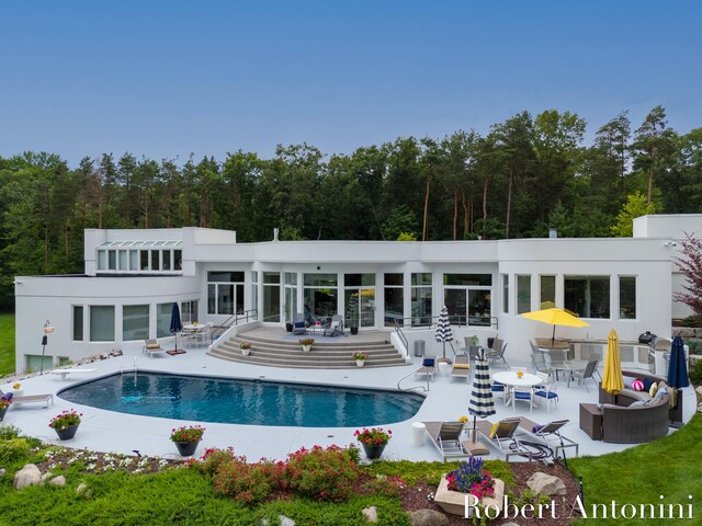 rear view of property featuring outdoor lounge area and a patio