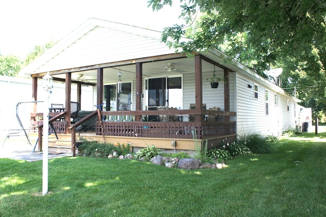 view of front of property with a front yard, a porch, and ceiling fan