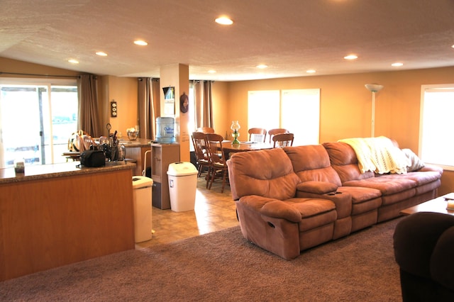 living room featuring light carpet and a textured ceiling