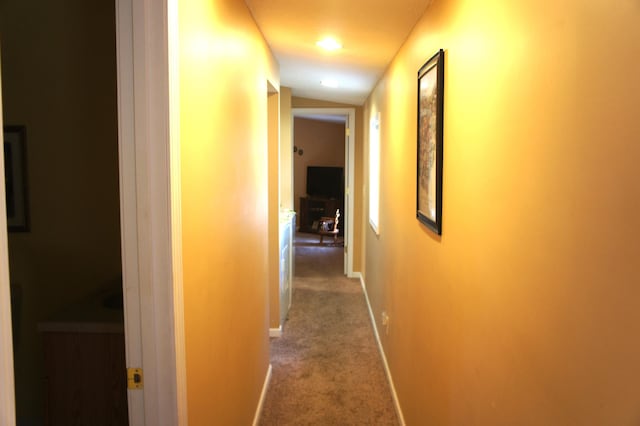 hall featuring carpet and vaulted ceiling