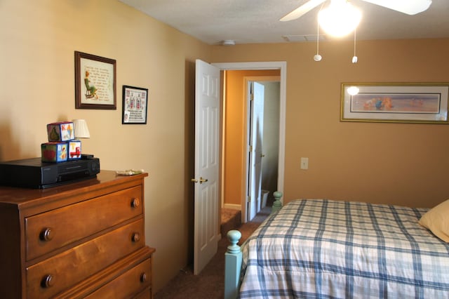 bedroom featuring dark carpet and ceiling fan