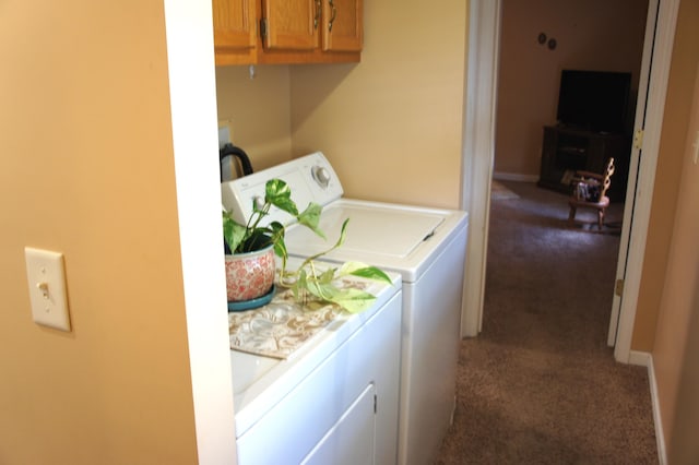 laundry area featuring washer and clothes dryer and dark colored carpet