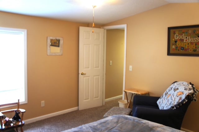 living area featuring carpet flooring and vaulted ceiling