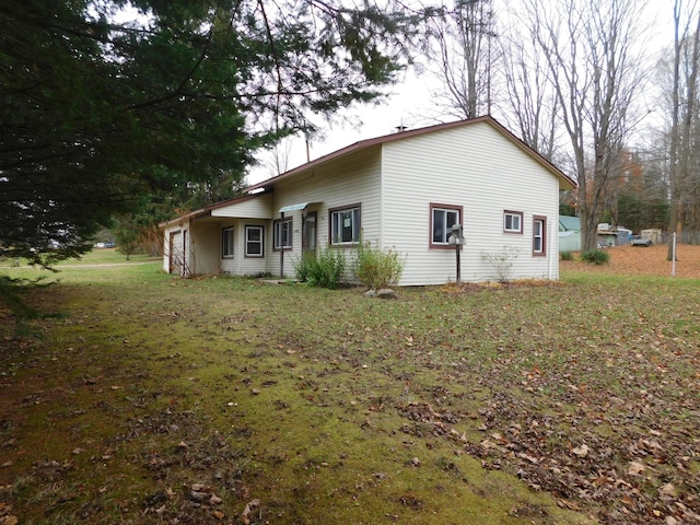 view of side of home with a lawn