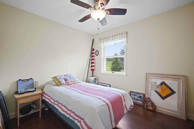 bedroom with ceiling fan and dark hardwood / wood-style flooring