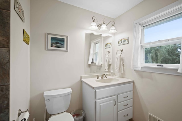 bathroom featuring vanity and toilet