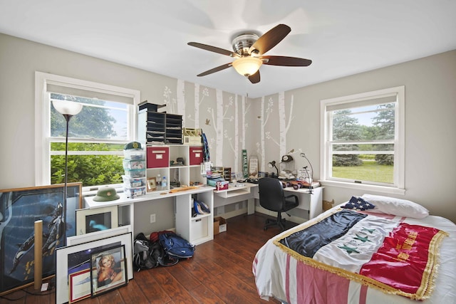 bedroom with ceiling fan and dark hardwood / wood-style floors