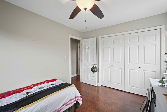 bedroom with ceiling fan, dark hardwood / wood-style floors, and a closet