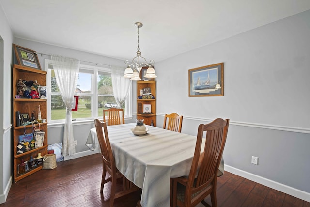 dining room featuring dark hardwood / wood-style floors and a chandelier