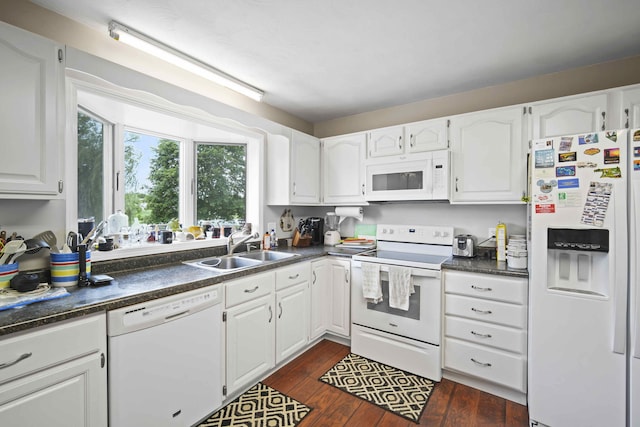 kitchen featuring white cabinetry, white appliances, dark hardwood / wood-style flooring, and sink