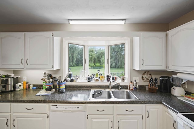 kitchen featuring white cabinetry, white appliances, and sink