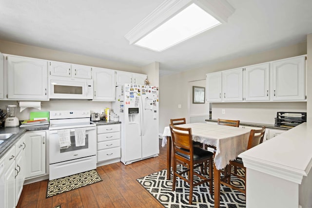 kitchen with white appliances, dark hardwood / wood-style flooring, and white cabinets