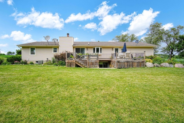 back of house with a wooden deck, central AC unit, and a lawn