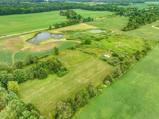 birds eye view of property with a water view and a rural view