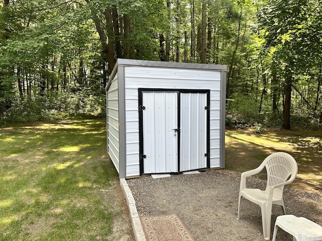 view of outbuilding featuring a yard