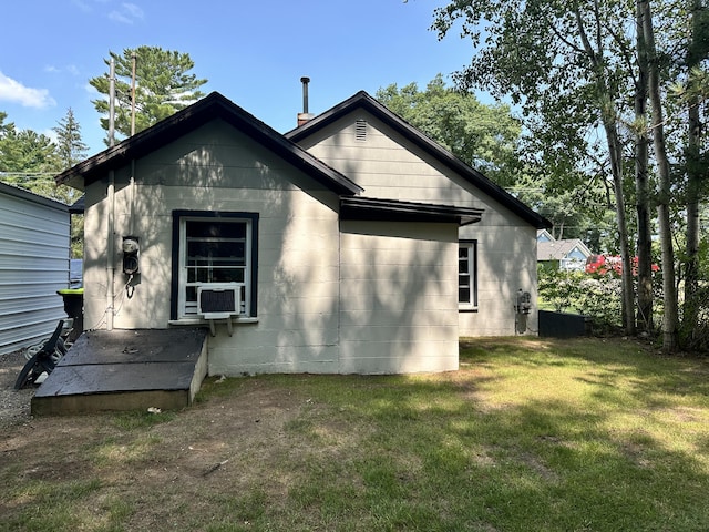 back of property with cooling unit and a yard