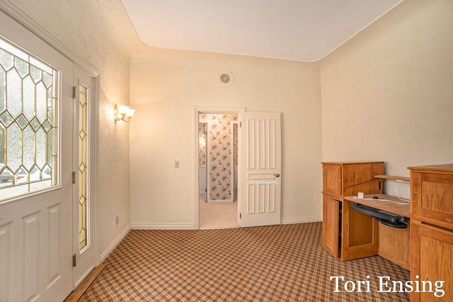 interior space featuring plenty of natural light and light carpet