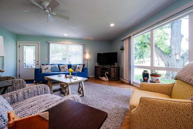 living room featuring ceiling fan and a healthy amount of sunlight