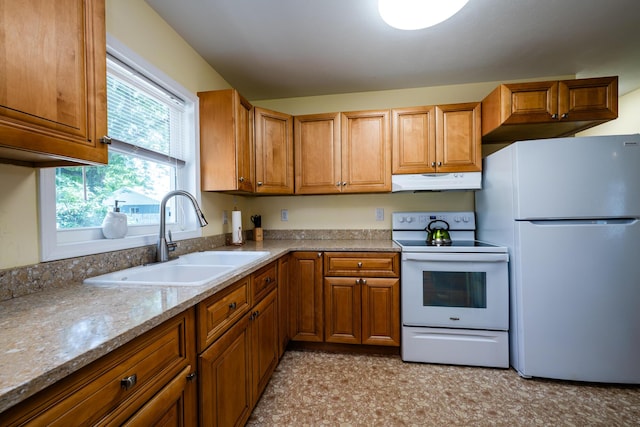 kitchen with fridge, white electric range oven, sink, and light stone counters