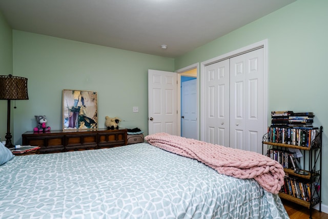 bedroom with hardwood / wood-style flooring and a closet