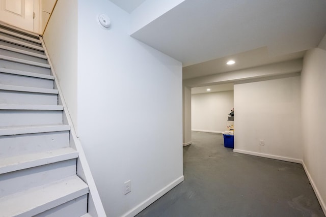 staircase with concrete floors