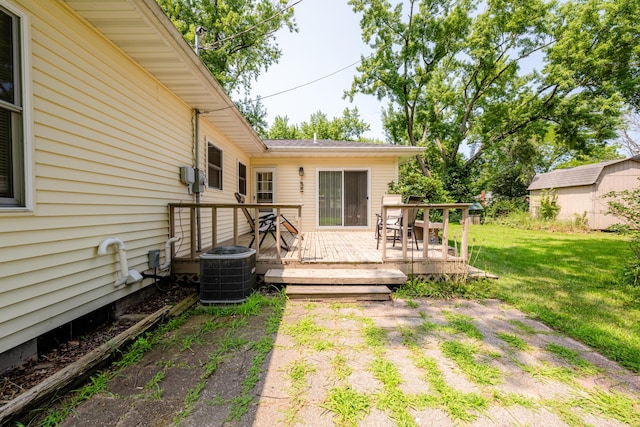 view of yard with a wooden deck, a shed, and central air condition unit