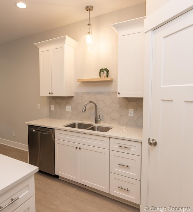 kitchen with sink, hanging light fixtures, tasteful backsplash, white cabinets, and stainless steel dishwasher