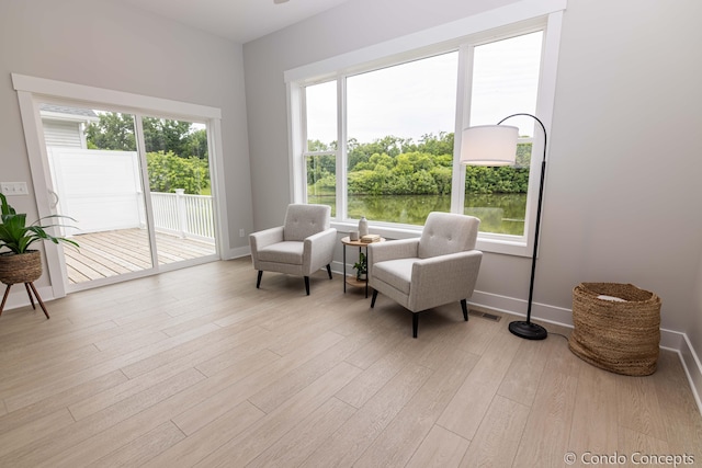 sitting room featuring a healthy amount of sunlight and light hardwood / wood-style floors