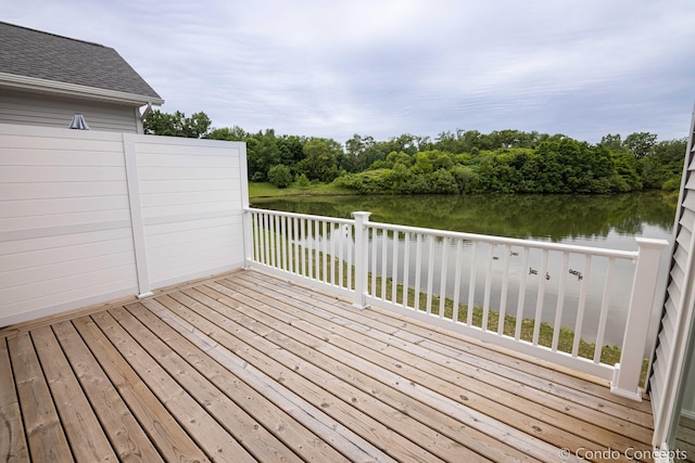 wooden terrace featuring a water view