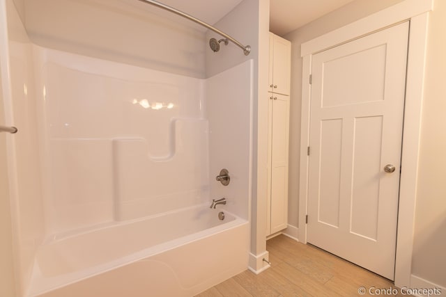 bathroom featuring bathtub / shower combination and hardwood / wood-style floors