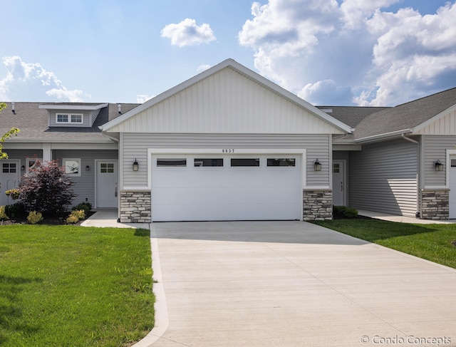 view of front of property featuring a garage and a front lawn