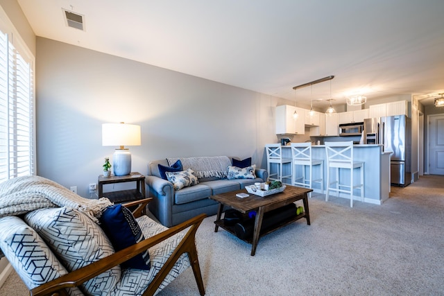 carpeted living room featuring a healthy amount of sunlight