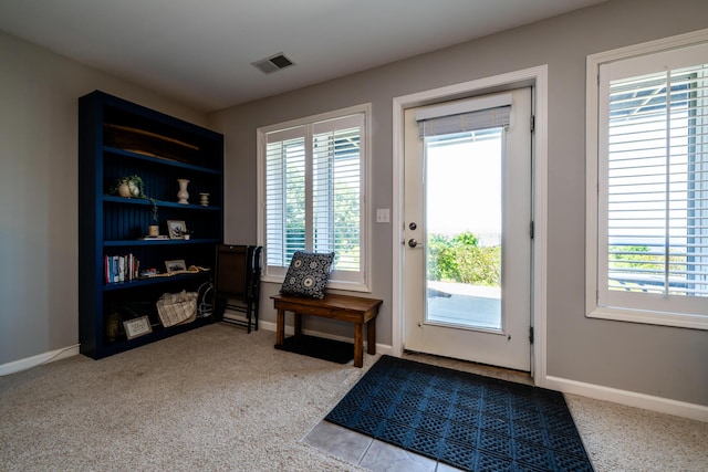 doorway featuring light colored carpet