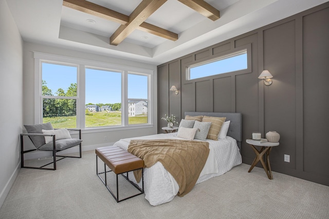 carpeted bedroom with beamed ceiling and coffered ceiling