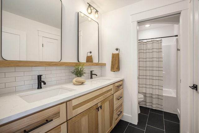 full bathroom featuring tasteful backsplash, vanity, tile patterned floors, toilet, and shower / bath combo with shower curtain