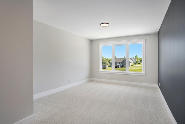 empty room with light colored carpet