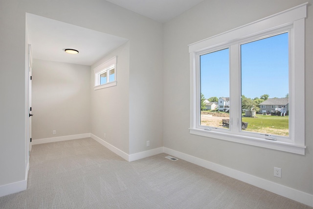 carpeted spare room with plenty of natural light