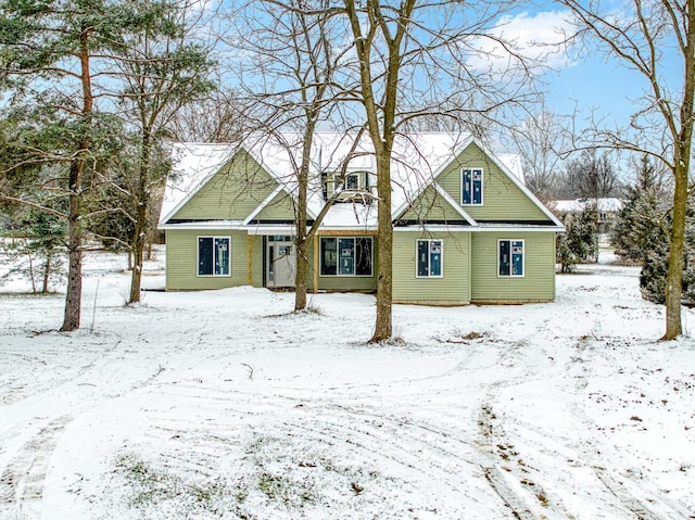 view of snow covered back of property