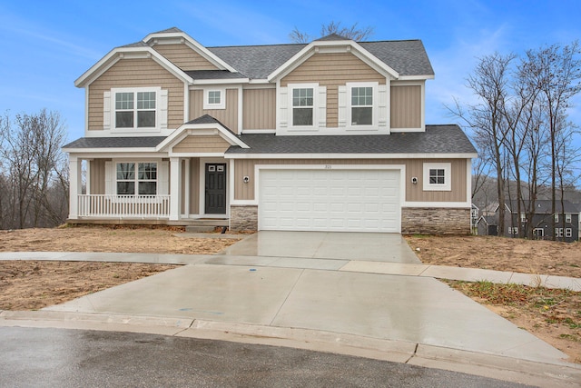 craftsman house featuring covered porch and a garage