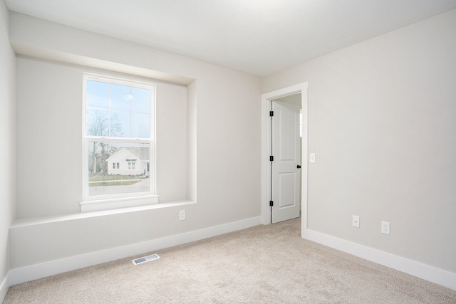 unfurnished room with light carpet