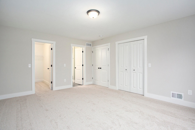 unfurnished bedroom featuring light carpet