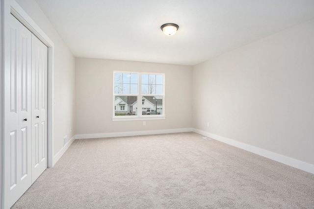 unfurnished bedroom with carpet floors and a closet